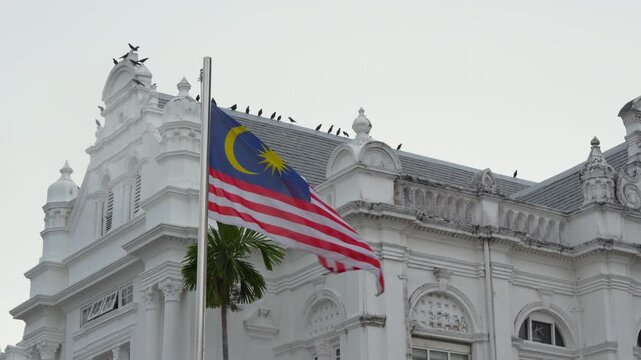 day time penang island george town city hall exterior national flag slow motion panorama 4k malaysia