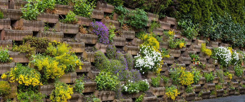 Tiered retaining wall blooming with colorful flowers