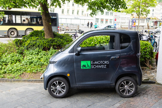 Electric microcar promoting E Motors Schweiz on urban street