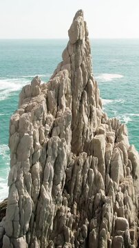 Dedo de Dios sea stack, iconic natural landmark at Maruata Beach, Michoacan, Mexico. Vertical closeup