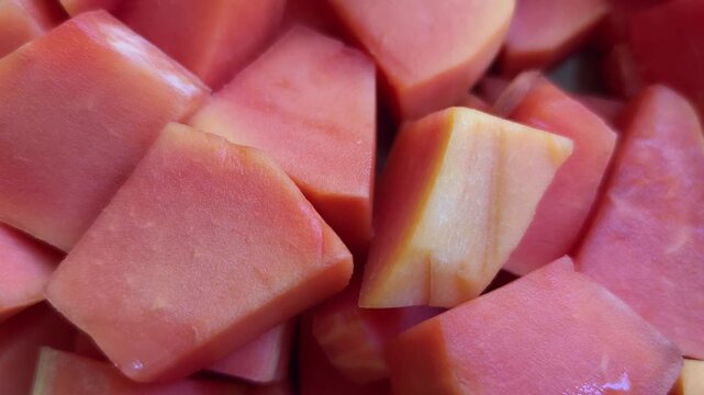 Close up of fresh ripe papaya fruit cut into cubes