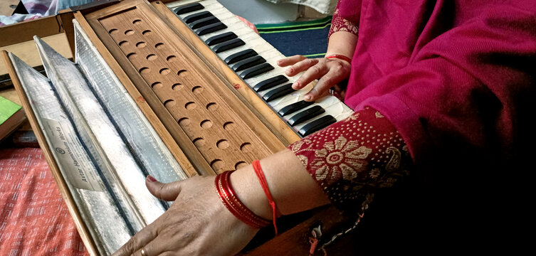 Woman Hand Playing Harmonium Keyboard. Traditional Indian Musical Instrument