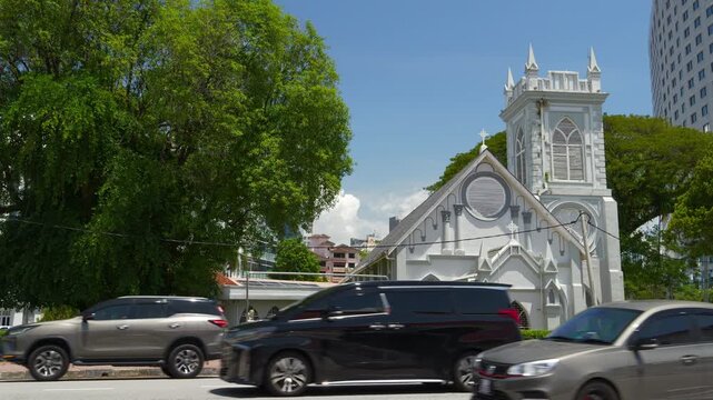 sunny day penang island george town famous church exterior traffic street slow motion panorama 4k malaysia