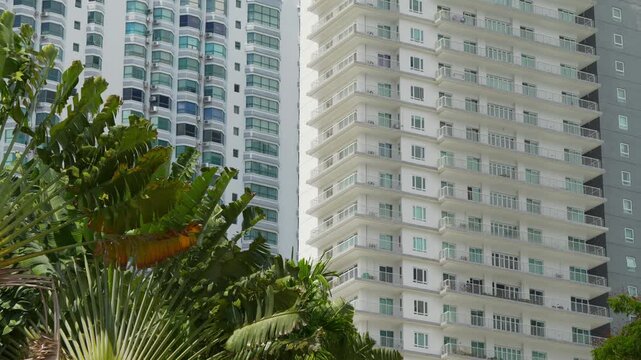 sunny day penang island george town modern apartment buildings exterior palm trees slow motion panorama 4k malaysia