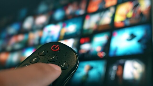 Using a remote to command a large-screen TV, viewers dive into a vast world of entertainment, embracing convenience, personalization, digital lifestyles, and the evolution of smart home technology.
