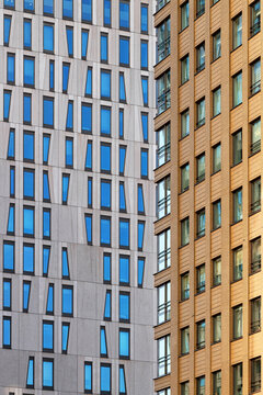 View of contrasting modern skyscraper facades with unique geometric window patterns and architectural details in Rotterdam, South Holland, Netherlands.