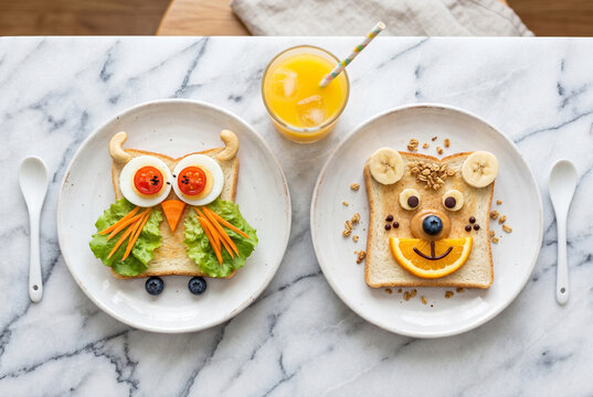 Kids food art with cute animal shaped toast and orange juice