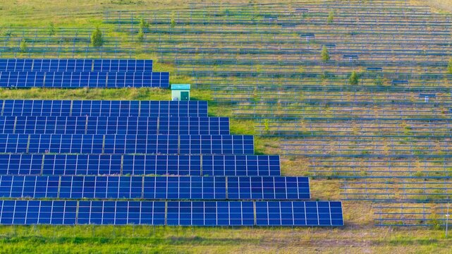 Newly installed solar panels in a renewable energy field, view of racked solar panels in a field, installing new power needed to generate energy from the sun.