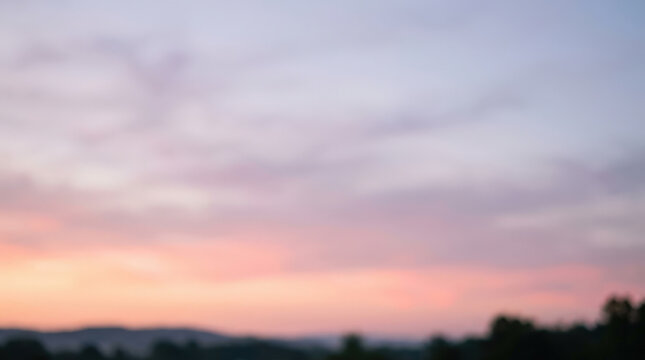 Soft sunset horizon with gentle clouds over rolling hills gradient