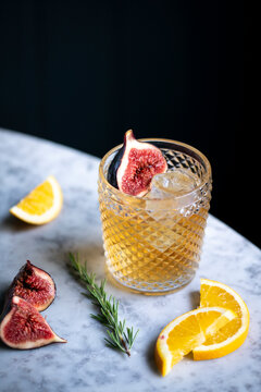 Refreshing Beverage With Fig and Citrus on a Stylish Marble Table in a Cozy Setting