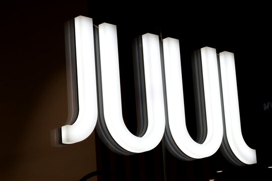 London, UK - December 18 2025: Illustrative editorial close-up of illuminated storefront sign with large white letters on a dark background in a London shopping centre