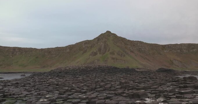 tilting shot revealing the hexagonal basalt rocks at the Giants Causeway