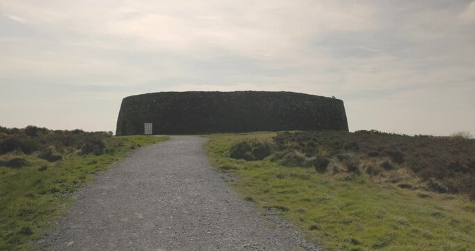 static shot revealing a tourist at the Grianan of Aileach in Ireland