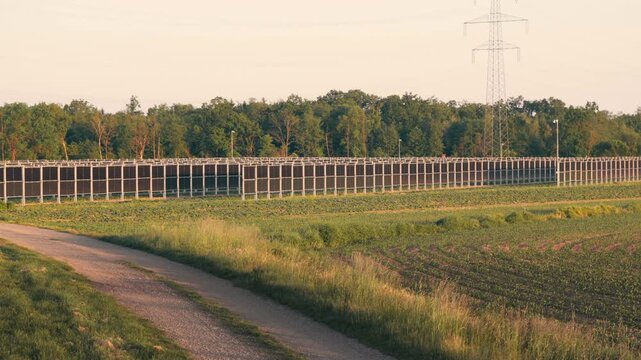 Innovative agrivoltaic installation with vertical solar panels in a rural field. Sustainable farming and renewable energy generation coexisting