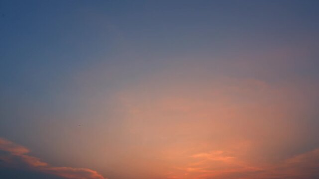 A sunset sky timelapse video footage featuring delicate Cirrus clouds glowing with warm orange and pink hues, symbolizing hope, reflection, and the beauty of new opportunities beyond the horizon. 4k.
