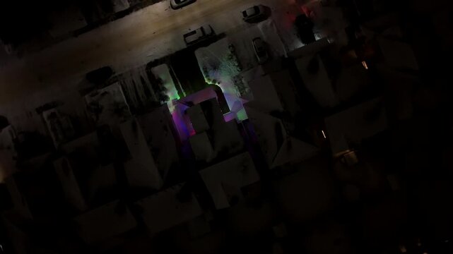 Cinematic circular aerial footage of a snow-covered residential neighborhood at night in Edmonton, Alberta, Canada. The orbiting drone perspective captures illuminated streets, suburban, winter views
