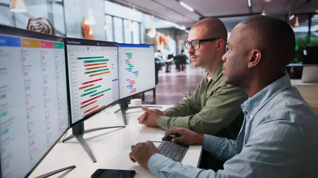 Project Managers Review Detailed Gantt Chart Schedules Together