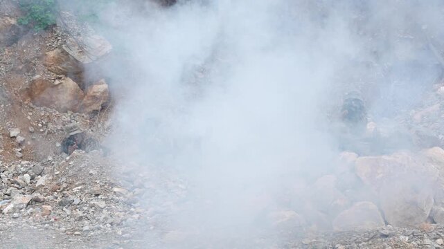 Military action scene in rocky terrain combat training outdoor environment intense atmosphere