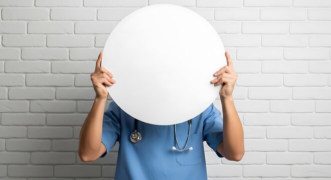 Medical holding blank white circle against brick wall