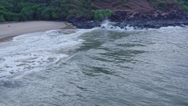 Aerial view of beach waves and hills creating scenic coastal landscape with natural beauty