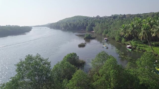 Aerial view of boating in Honnavar backwaters surrounded by palm trees and scenic beauty