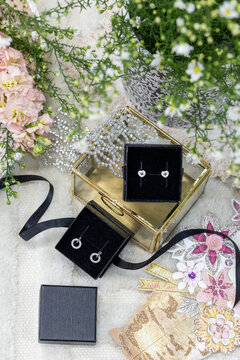 Luxury jewellery gift display with earrings flowers and Mother's Day styling