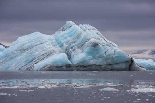 Floating chunk of ice before a huge glacier in Hornsund, Arctic, Svalbard, Norway