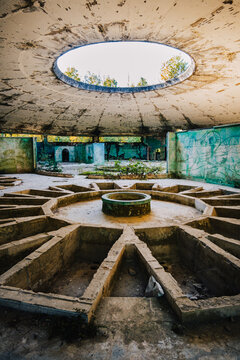 Interior of abandoned Bathhouse #8 in Tskaltubo, Georgia, showcasing a striking skylight and decaying Soviet spa architecture.