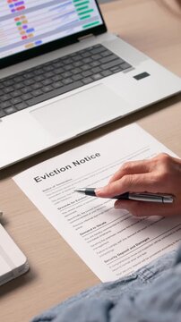 Person Reviewing Eviction Notice Document Before Court Hearing