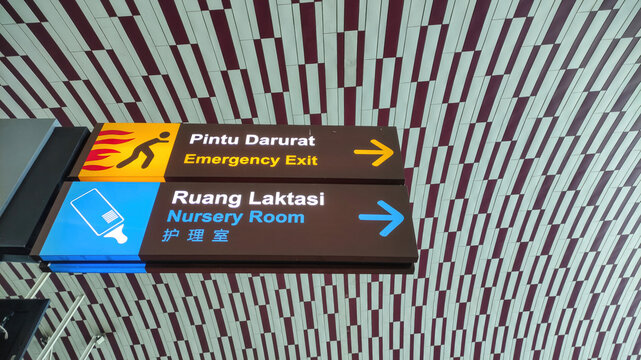 Multilingual Emergency Exit and Nursery Room Signage in Airport