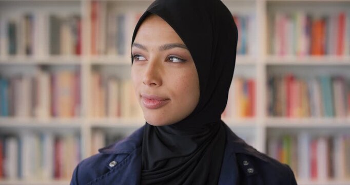 Face, student or Muslim woman in library with college education, knowledge or vision for development. Islamic person, thinking or study at university campus with reflection, learning or future growth