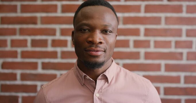 Creative, face and businessman with pride, brick wall and ambitious for marketing career development. Business, brand manager or black person with job for opportunity, portrait and confident in Kenya
