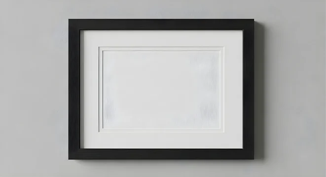 Blank black picture frame mockup on a grey wall.