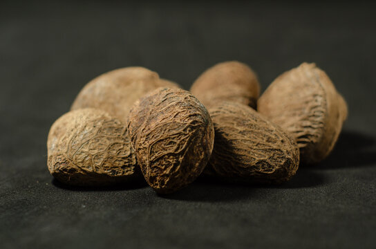 Raw Kluwak Nuts on Dark Background