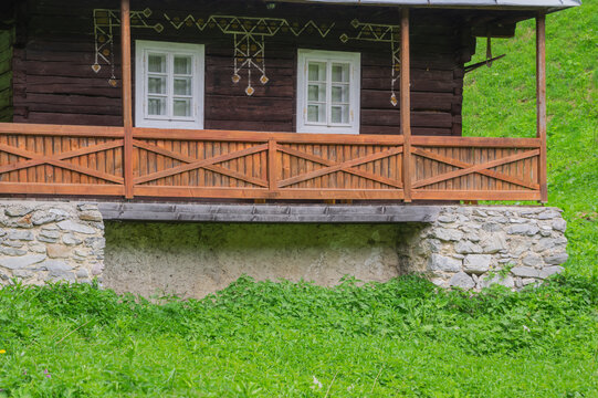 View of the traditional wooden architecture at the former charcoal workers' settlement Moce with white window frames in Motycky, Banska Bystrica Regio, Slovakia.