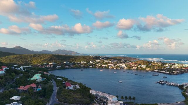 Aerial view of Oyster Pond on Saint Martin island in the Caribbean Sea. Coastal town with residential buildings and resort hotels is located on the border of French and Dutch sides.