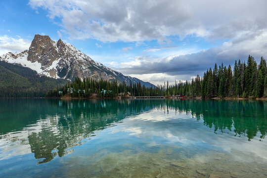 Calm turquoise water reflects mountains at Emerald Lake