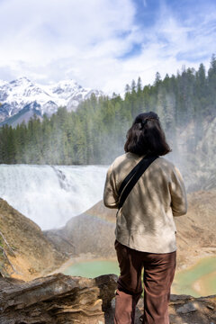 Woman watching Wapta Falls in Yoho National Park