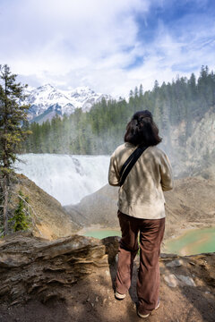Woman watching Wapta Falls in Yoho National Park