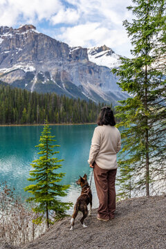 Woman with her dog enjoying a scenic mountain view