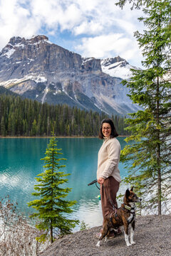 Woman and dog enjoying view of Emerald Lake, Yoho National Park