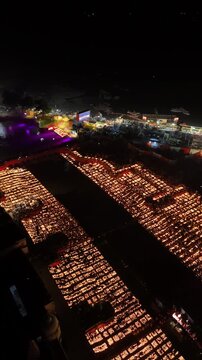 Ayodhya, India - 30 October 2024: Aerial view of thousands of oil lamps lit along the river banks during the Deepotsav festival celebration at night.