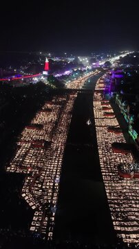Ayodhya, India - 30 October 2024: Aerial view of thousands of oil lamps illuminating the Ram Ki Paidi ghats during the Deepotsav festival at night.