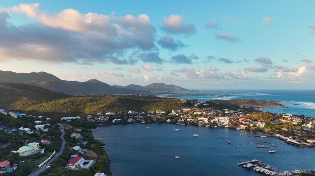 Aerial view of Oyster Pond on Saint Martin island in the Caribbean Sea. Coastal town with residential buildings and resort hotels is located on the border of French and Dutch sides. 