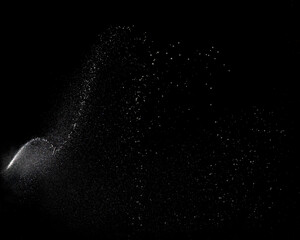 champagne spray captured against a black background with floating droplets and fizz. Ideal for wedding graphics, senior graduations, event advertising and digital design overlays. © Chris Chambers