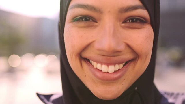 Smile, outdoor and face of muslim woman in city for university, education or studying with confidence. Hijab, portrait and islamic student in town with positive attitude for religion or academy