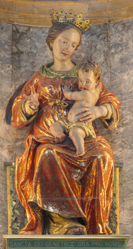 BERGAMO, ITALY - MARCH 18, 2026: The carved polychrome baroque statue of Madonna in the church Chiesa di San Leonardo by unknown artist. 