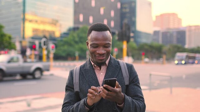 Business, text or black man in city with phone, online chat or agenda update on morning commute. Digital, wind or employee with tech, schedule change or message notification in travel routine.