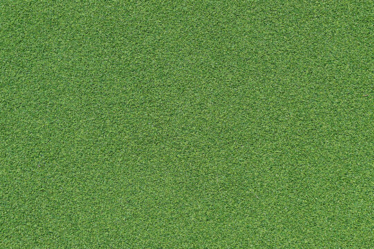 Close up of green artificial turf texture, flat lay abstract background for sports, eco and environment concept