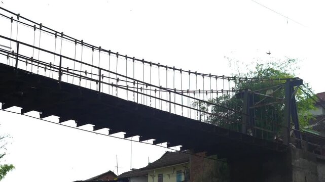 Low Angle View of People Crossing a Suspension Bridge